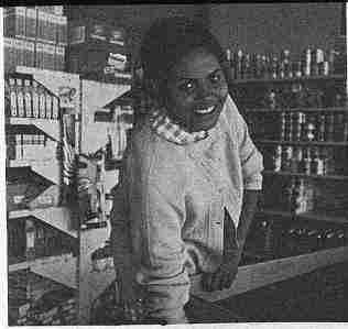 A modern half-blooded Aborigine woman working in a supermarket.